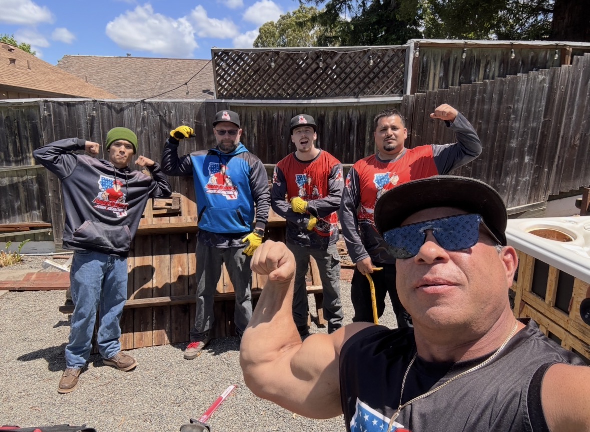 The Fuhgeddaboutit Junk Removal crew flexing in their branded gear in Petaluma
