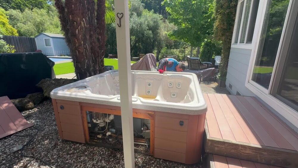Fuhgeddaboutit crew removing an old hot tub from a backyard deck